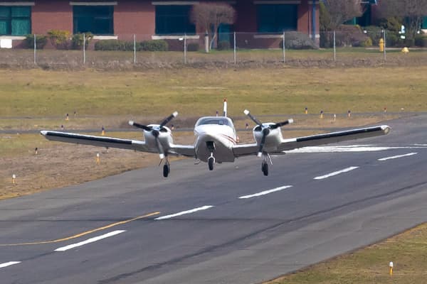 Twin engine aircraft taking off from airport